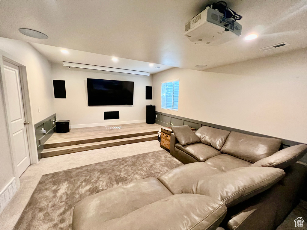 Cinema room featuring light carpet