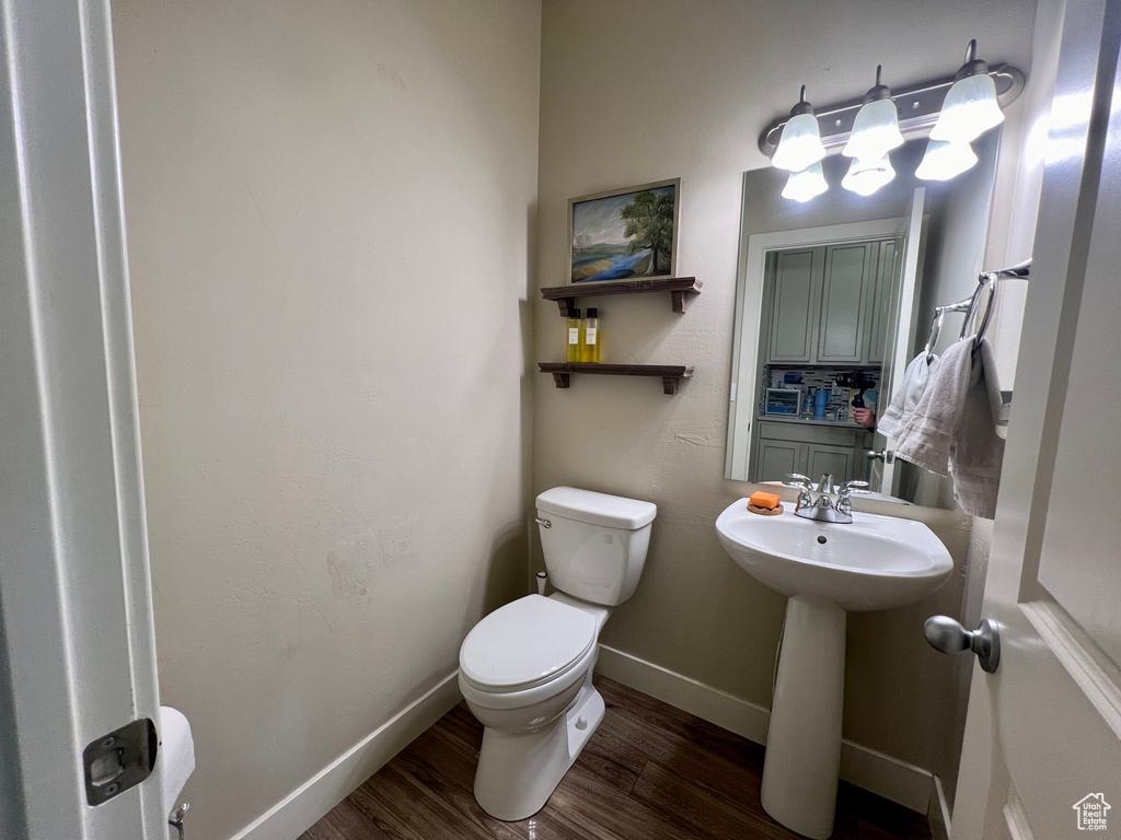 Bathroom featuring wood-type flooring and toilet