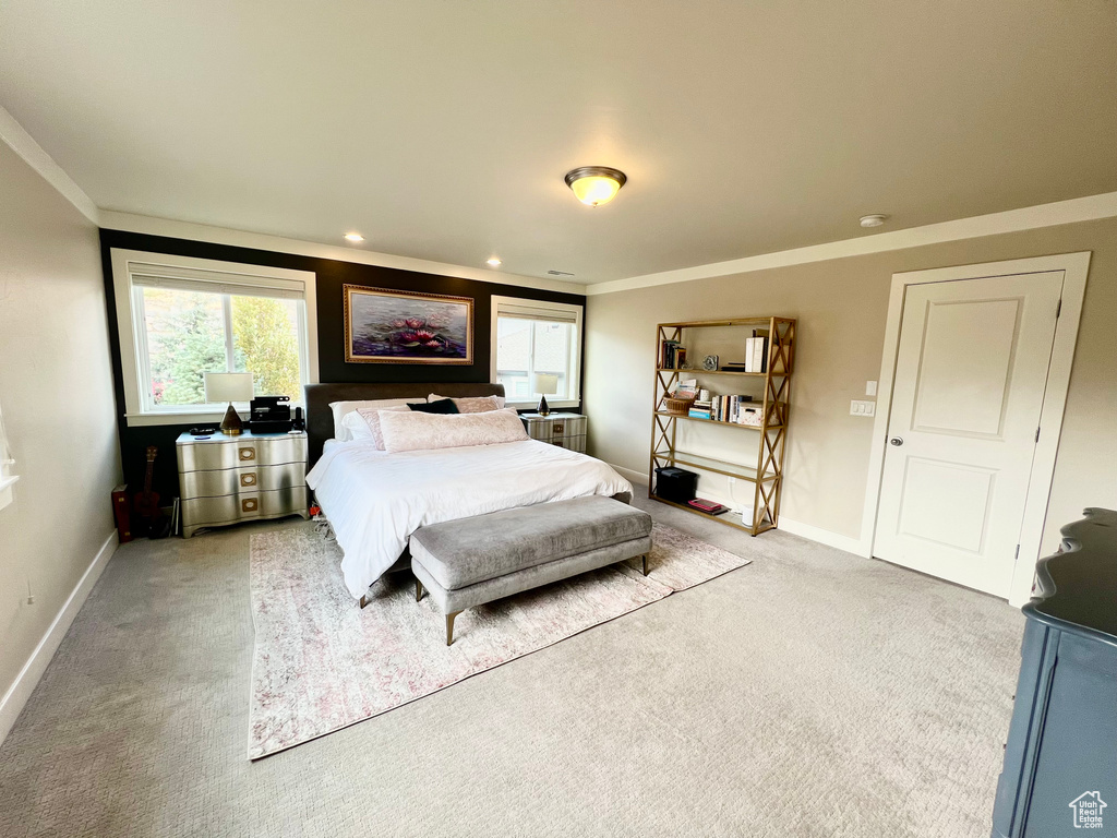 Bedroom featuring crown molding and light colored carpet