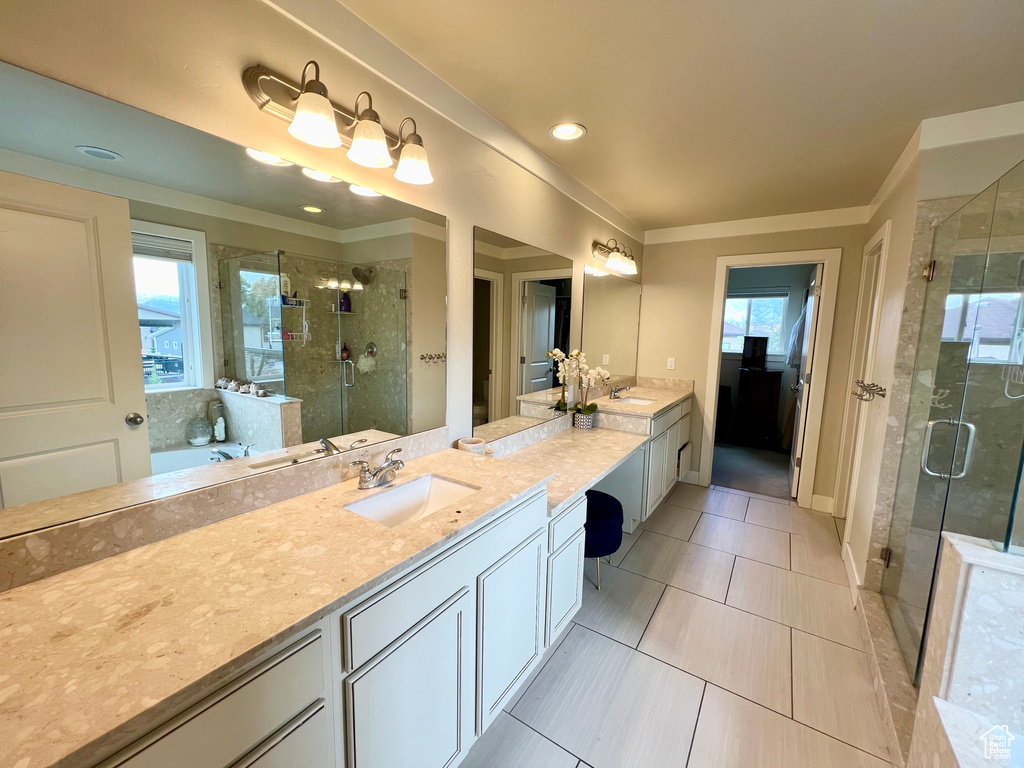 Bathroom with vanity, independent shower and bath, ornamental molding, and tile patterned flooring