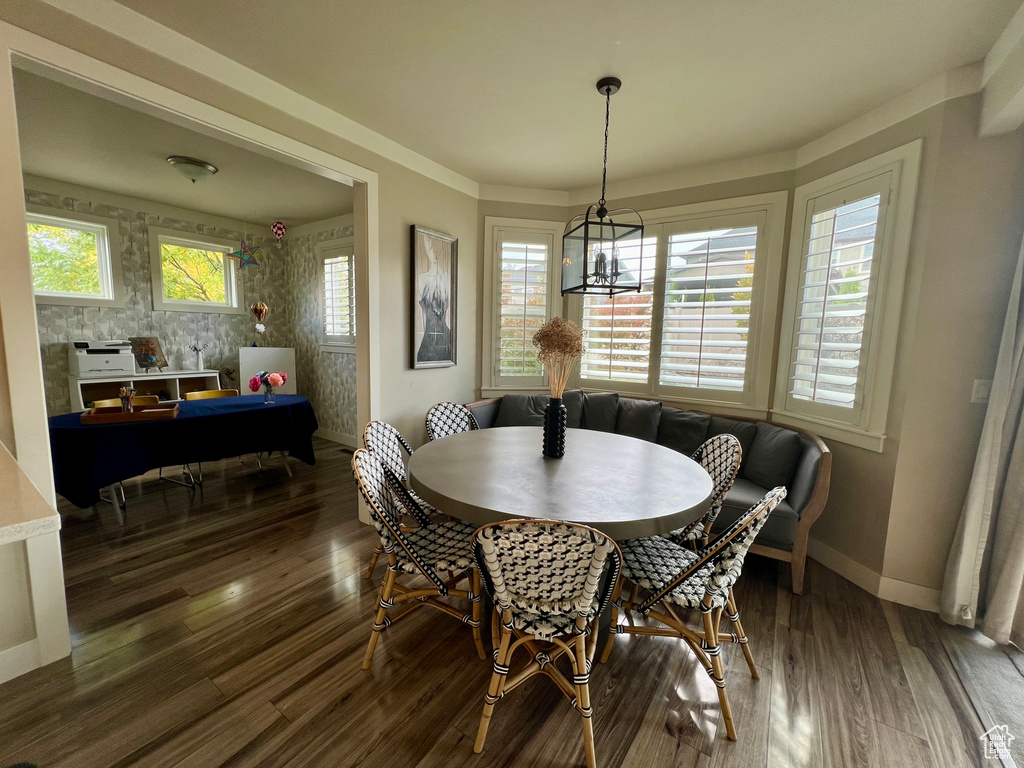 Dining space featuring breakfast area, an inviting chandelier, and dark hardwood / wood-style floors