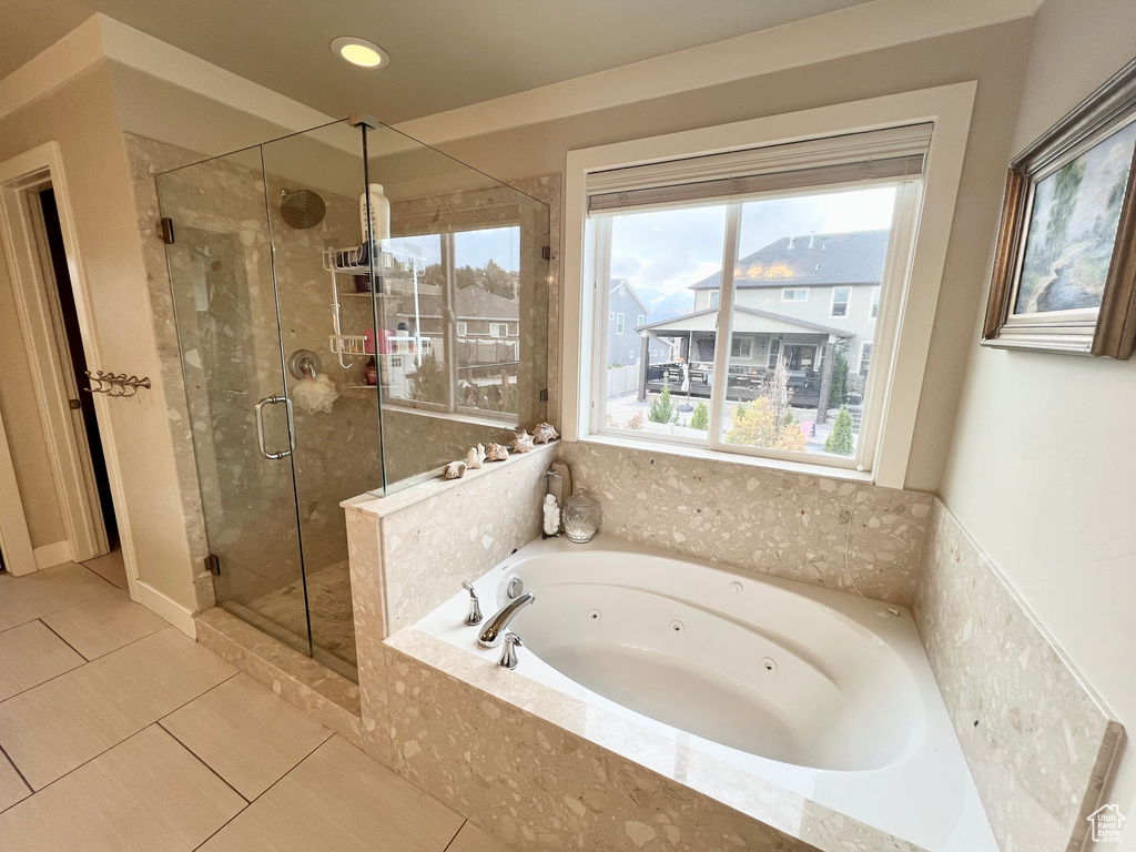 Bathroom featuring independent shower and bath, tile patterned floors, and a wealth of natural light