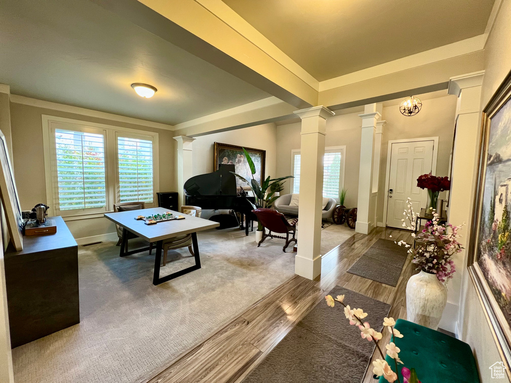 Interior space featuring a chandelier, wood-type flooring, and decorative columns