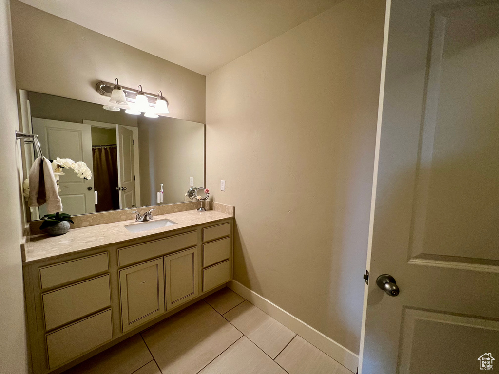 Bathroom featuring vanity and tile patterned floors