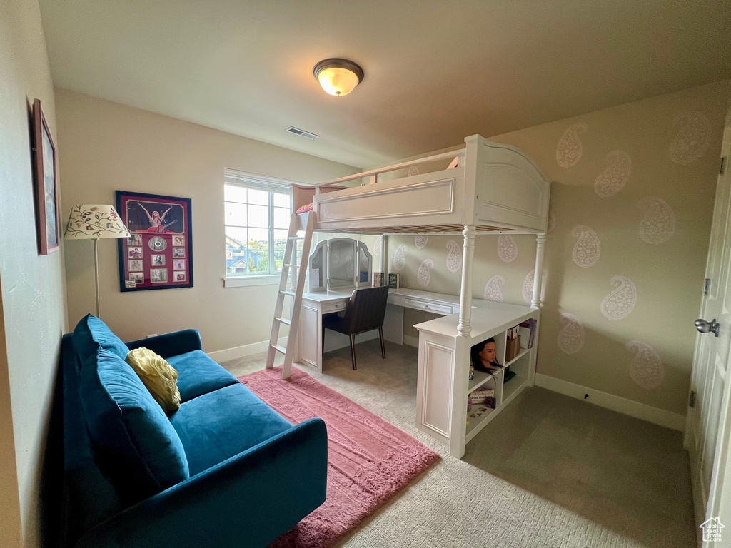 Bedroom with light colored carpet