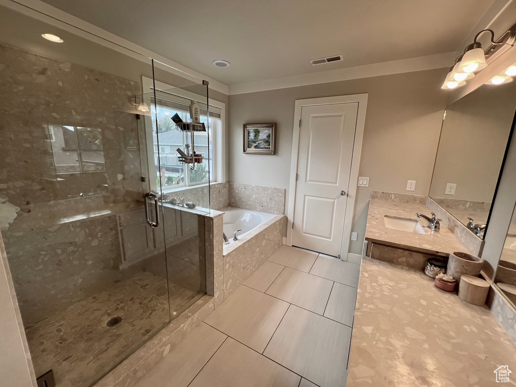 Bathroom with vanity, plus walk in shower, and tile patterned flooring