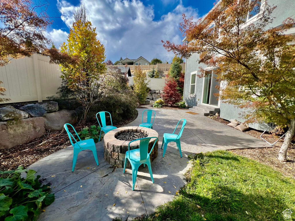 View of patio featuring an outdoor fire pit