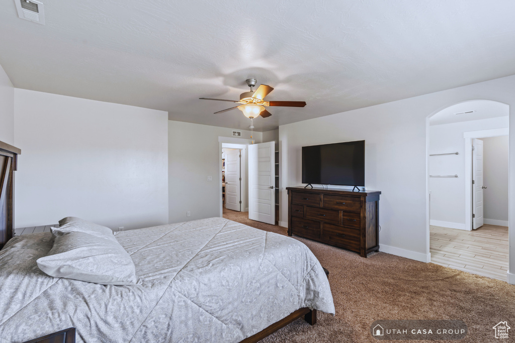 Bedroom featuring ceiling fan and light colored carpet