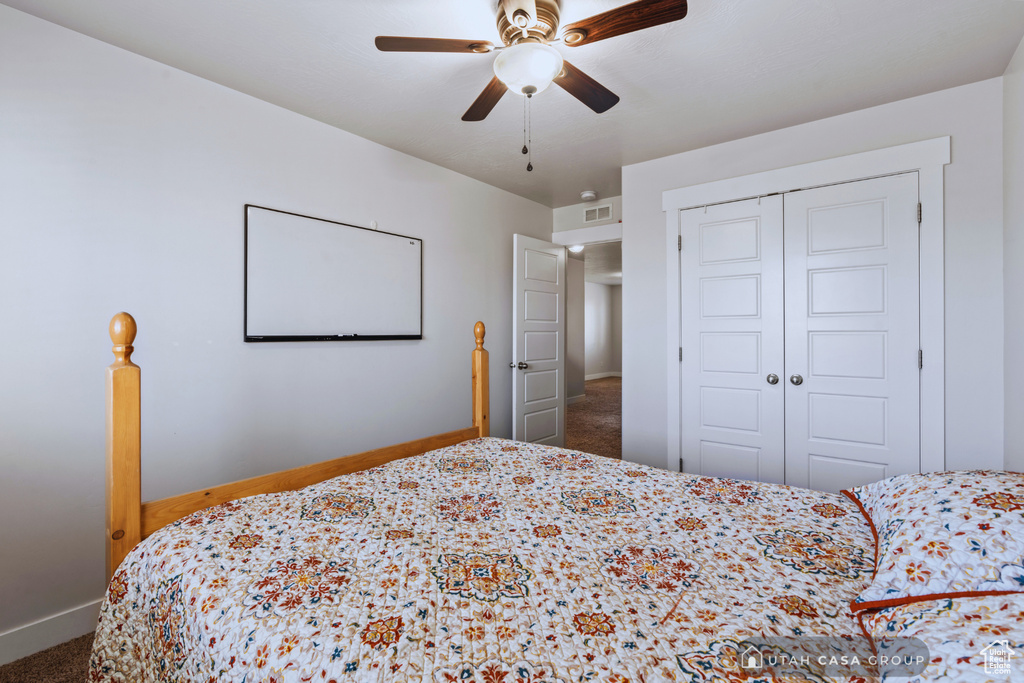 Bedroom featuring a closet, carpet, and ceiling fan