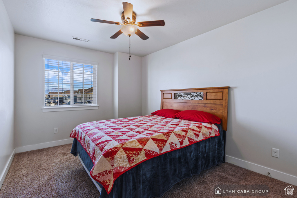 Carpeted bedroom with ceiling fan