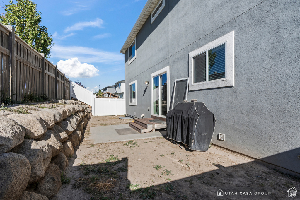 View of side of home with a patio