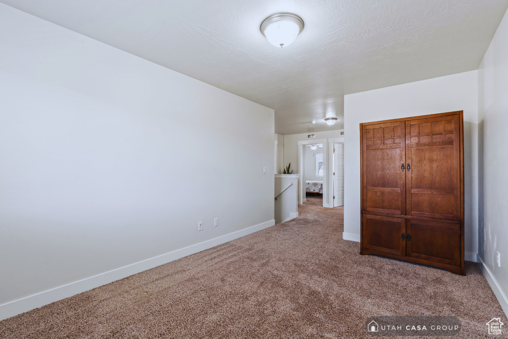 Unfurnished bedroom with carpet