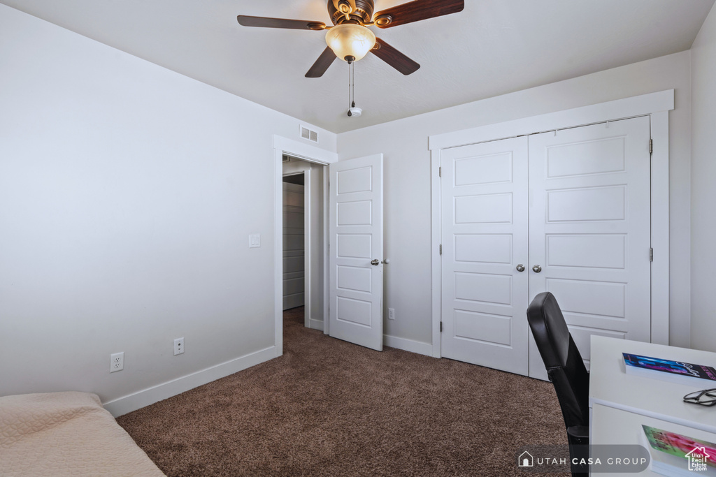 Carpeted office space with ceiling fan