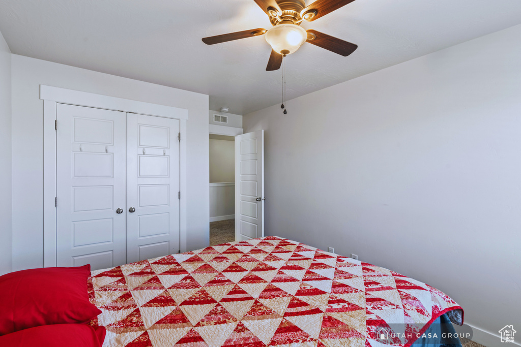 Unfurnished bedroom featuring a closet, ceiling fan, and carpet floors