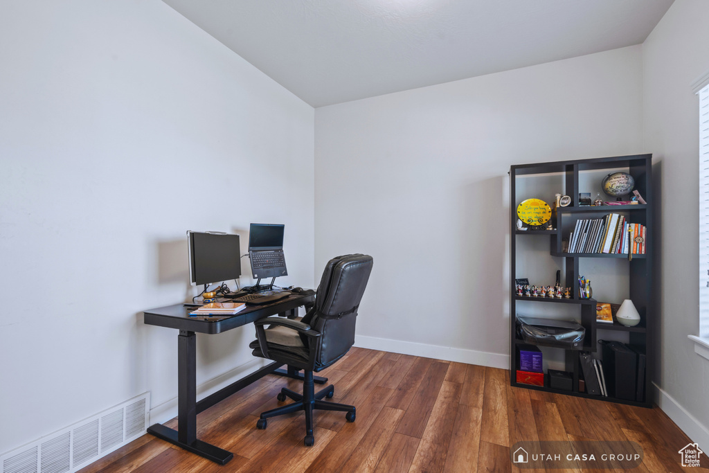 Office area with dark wood-type flooring