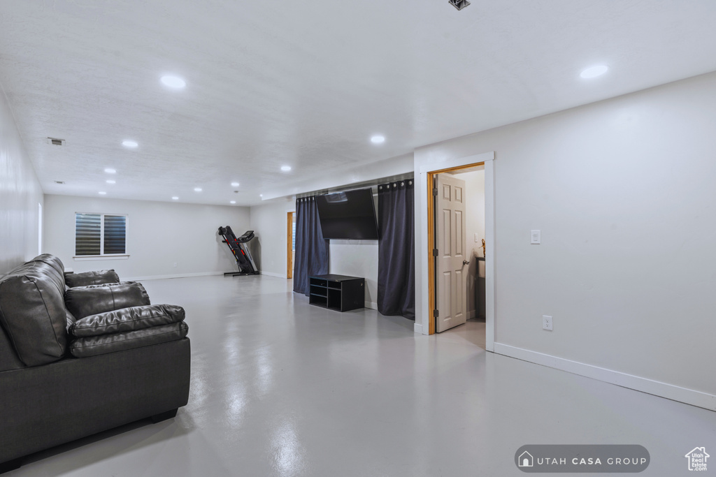 Living room featuring concrete flooring