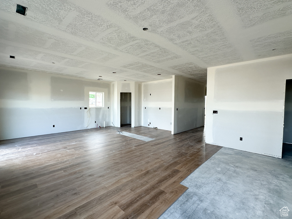 Unfurnished living room featuring dark hardwood / wood-style floors