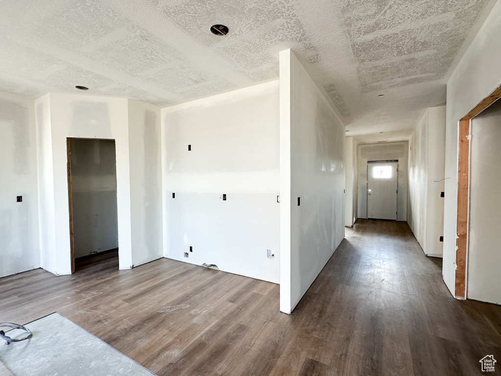 Interior space featuring a textured ceiling and wood-type flooring