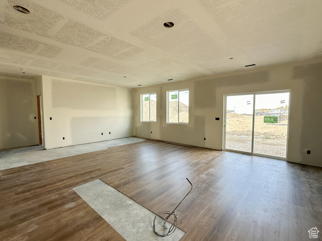 Empty room with hardwood / wood-style floors