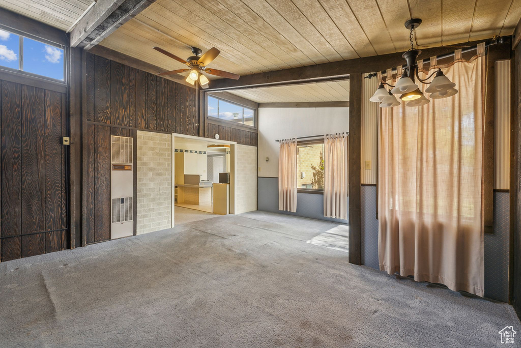 Spare room with beam ceiling, ceiling fan, high vaulted ceiling, wooden ceiling, and carpet flooring