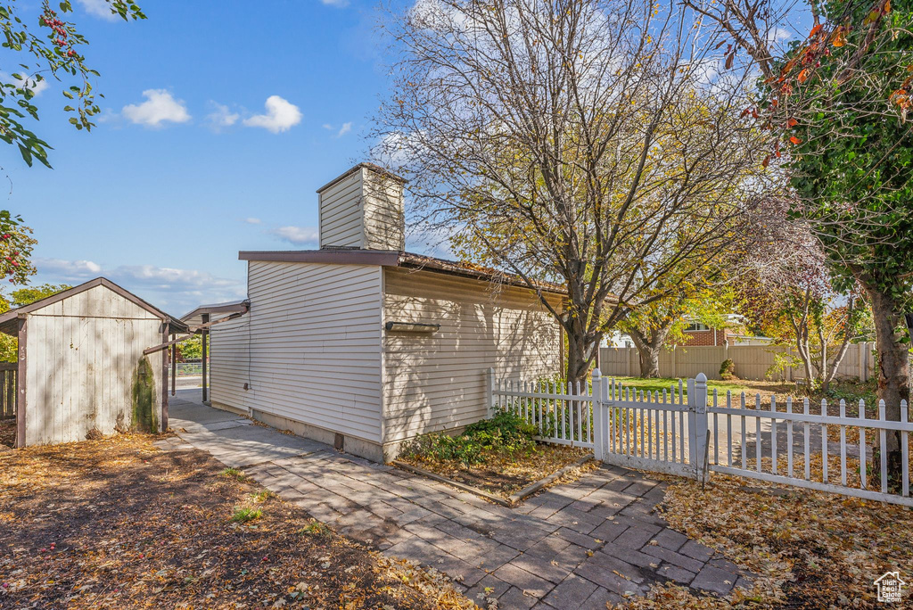 View of side of property featuring a storage unit