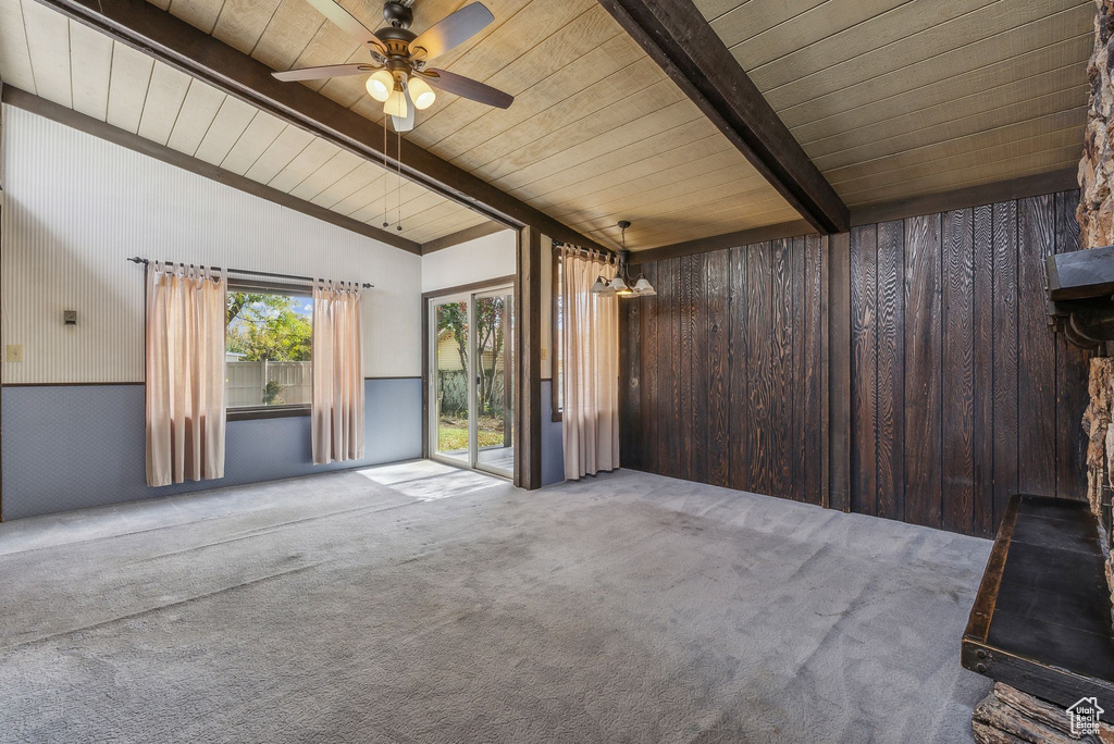 Spare room with lofted ceiling with beams, wooden ceiling, carpet, and ceiling fan