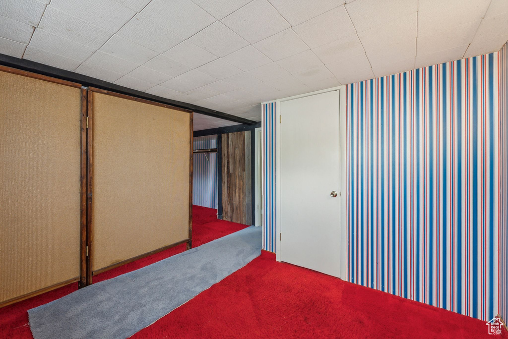 Basement featuring dark colored carpet