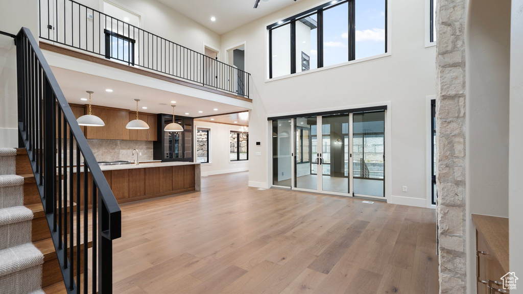 Interior space with sink, light wood-type flooring, and a towering ceiling