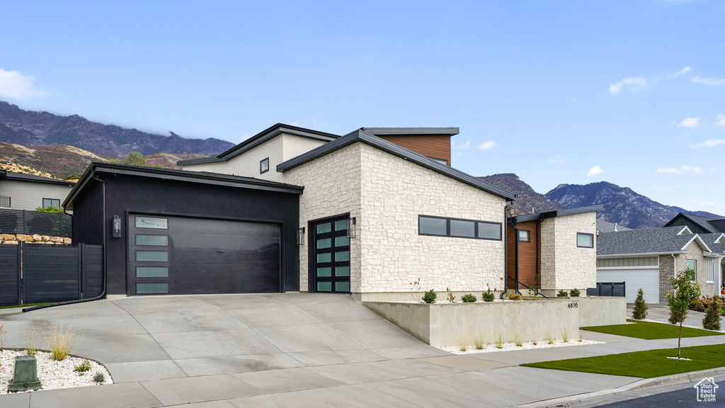 View of front facade featuring a mountain view and a garage