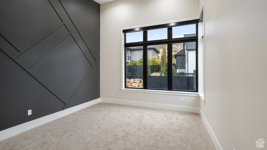 Empty room featuring light colored carpet