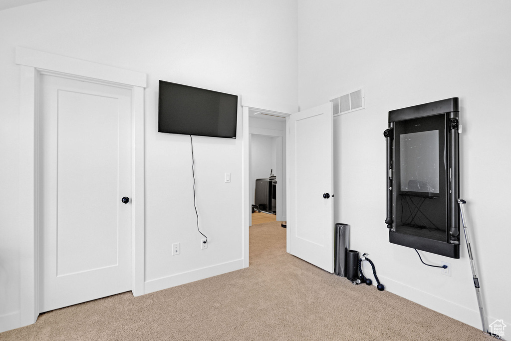 Unfurnished bedroom with light colored carpet