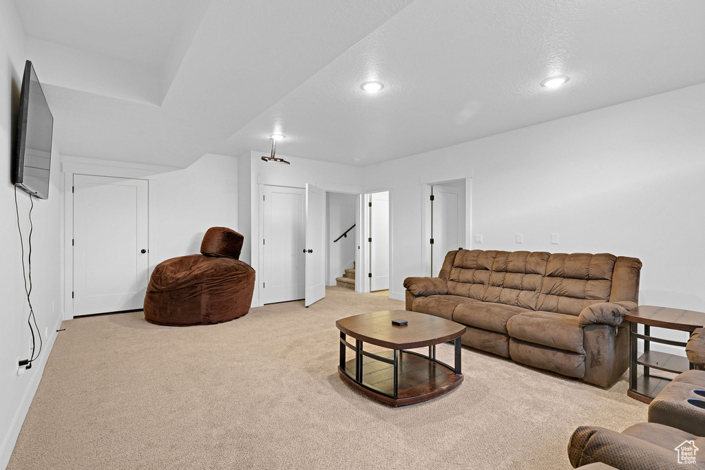 Living room with light carpet and a textured ceiling