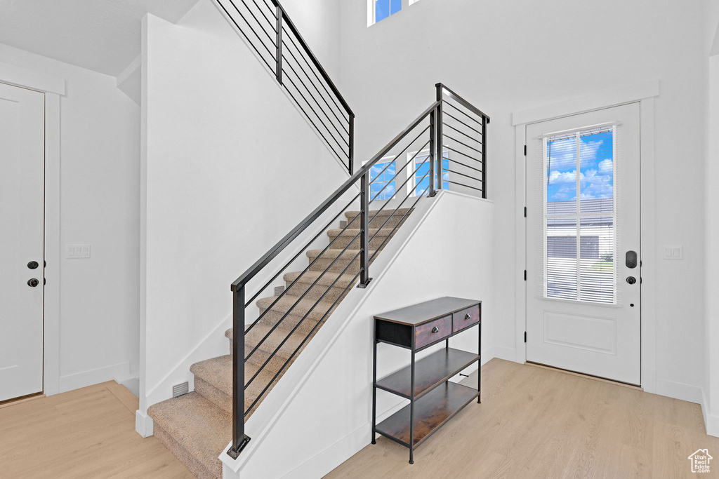 Foyer with light hardwood / wood-style floors