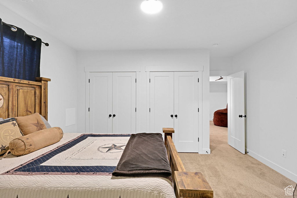 Carpeted bedroom featuring two closets