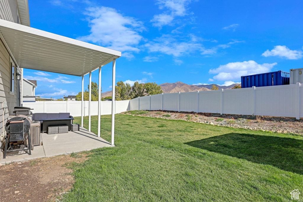 View of yard featuring a mountain view and a patio area