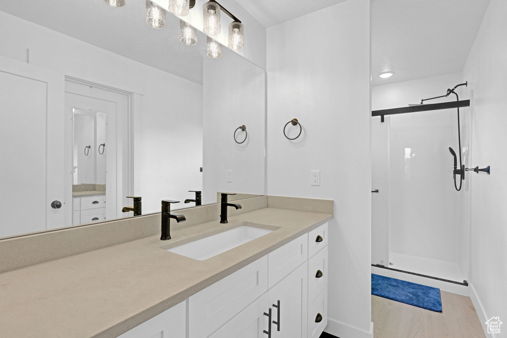 Bathroom with vanity, hardwood / wood-style floors, and walk in shower