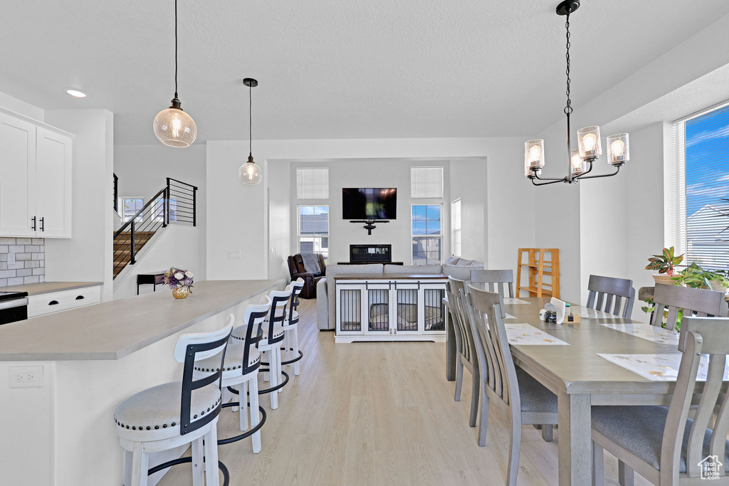 Dining room featuring a chandelier and light hardwood / wood-style flooring