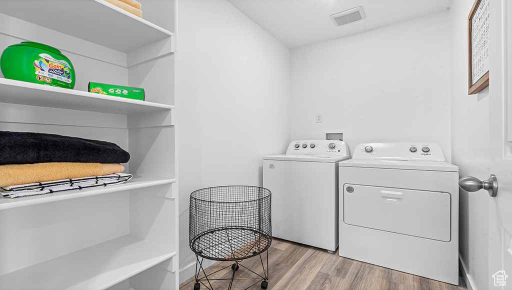 Laundry area featuring light hardwood / wood-style floors and independent washer and dryer