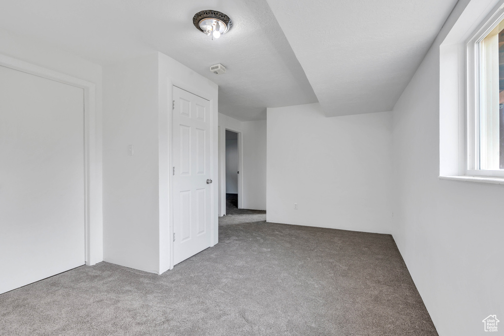 Additional living space with light carpet