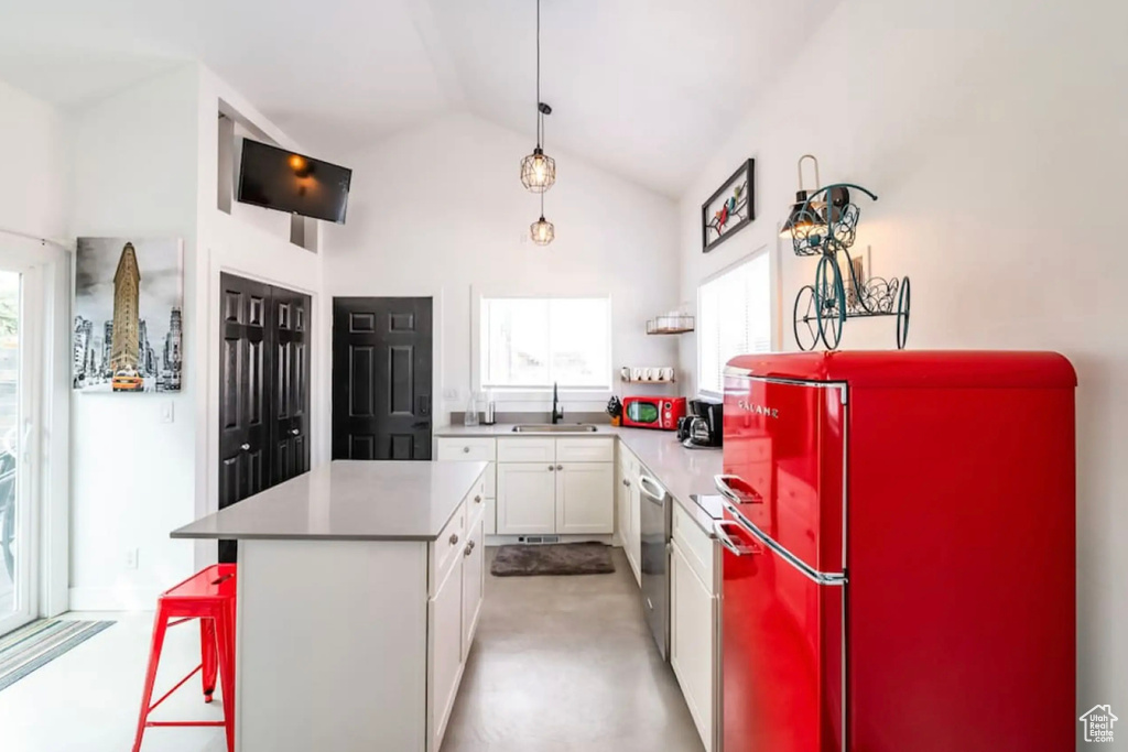 Kitchen featuring white cabinets, stainless steel appliances, sink, and a wealth of natural light