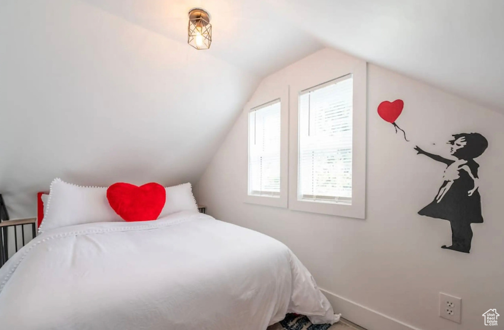 Bedroom featuring vaulted ceiling