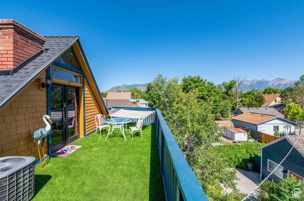 View of yard with cooling unit and a mountain view