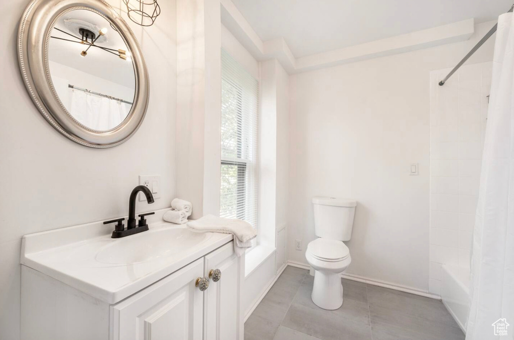 Full bathroom with vanity, toilet, and shower / bath combination with curtain