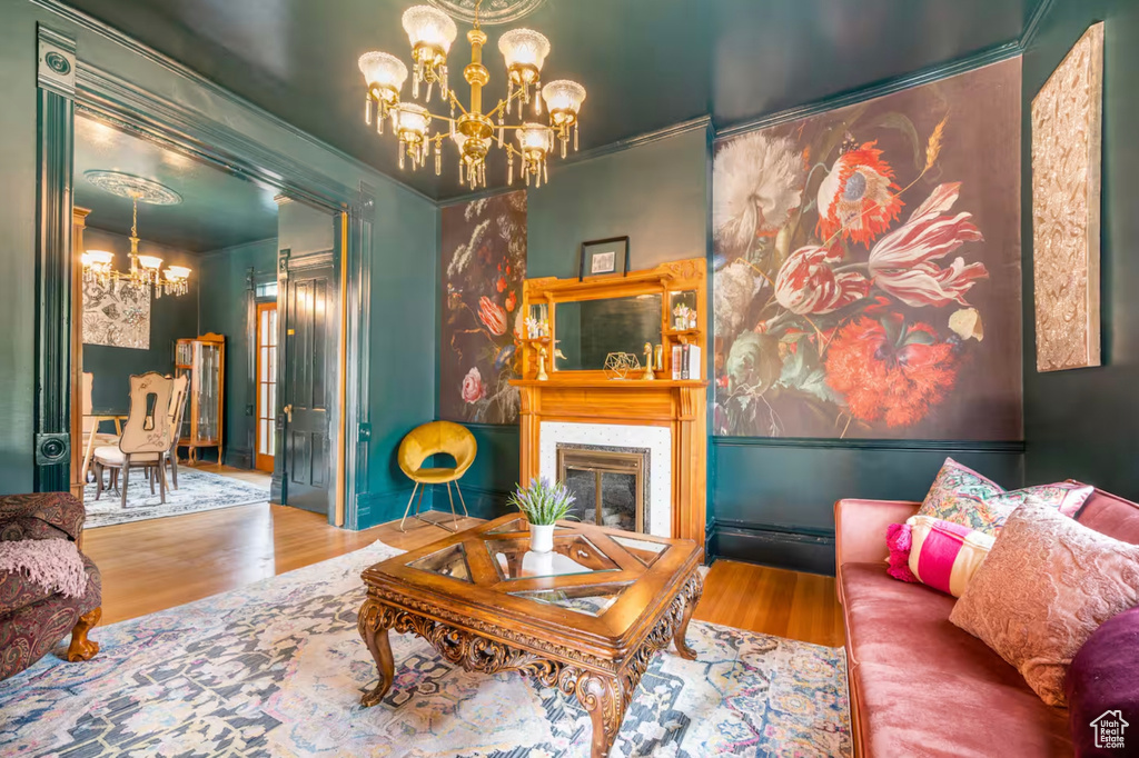 Living room with ornamental molding and hardwood / wood-style flooring