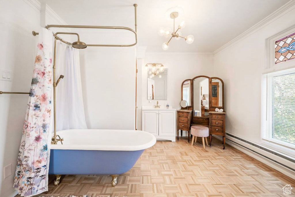 Bathroom featuring a baseboard radiator, shower / bath combo with shower curtain, ornamental molding, parquet flooring, and vanity