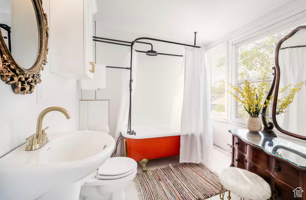 Full bathroom featuring tile patterned floors, sink, shower / bath combo, and toilet