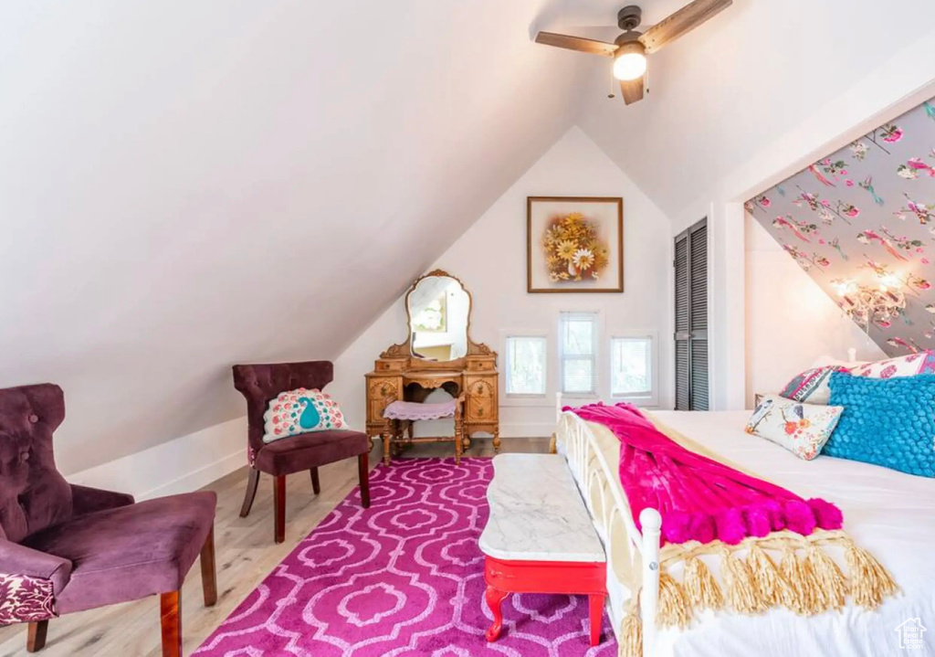 Bedroom featuring a closet, ceiling fan, vaulted ceiling, and hardwood / wood-style floors