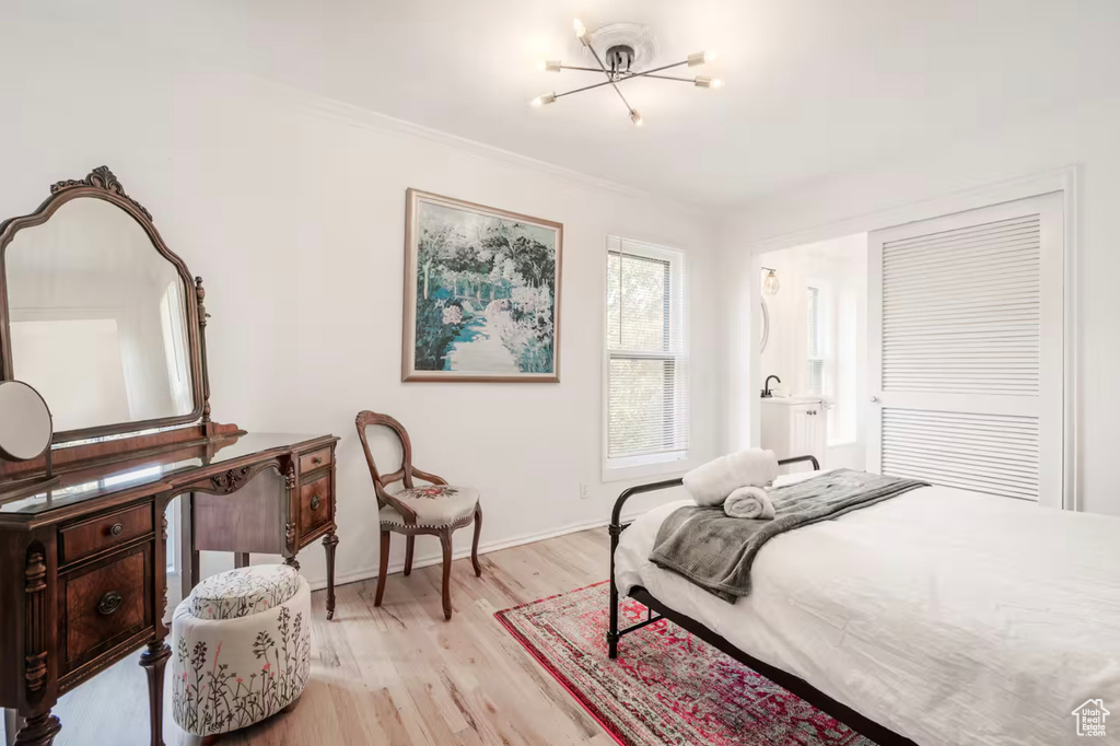 Bedroom featuring a notable chandelier and light wood-type flooring