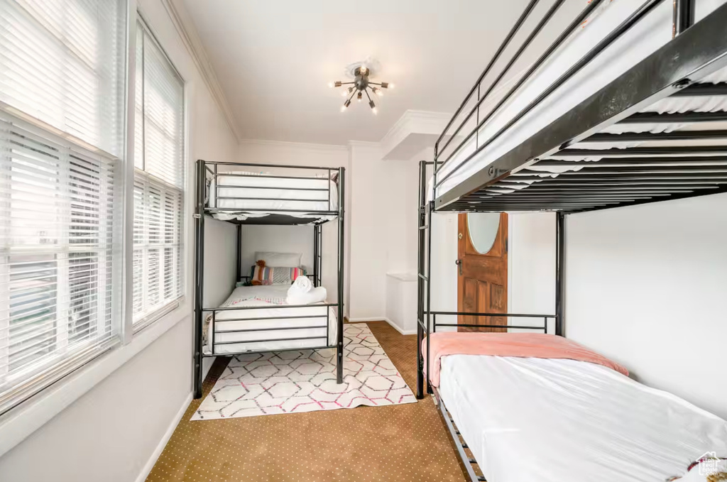 Bedroom featuring ornamental molding and light colored carpet