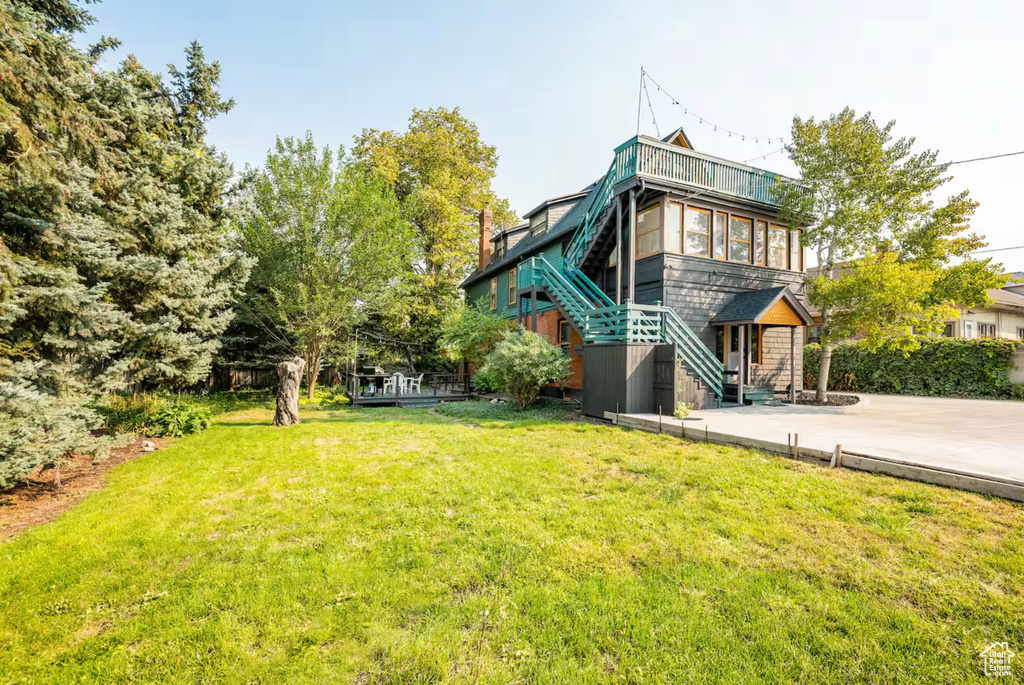 Back of house featuring a yard and a patio area